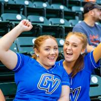 Photo of two young women cheering in the stands of Comerica Park